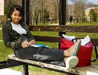 Penn State student waiting for an AMTRAN bus