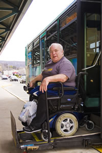 A picture of Bob Dubbs in front of an AMTRAN Bus